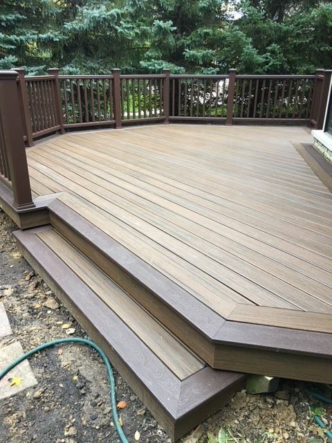 Picture-frame border boards and a wide angled step on a low composite deck