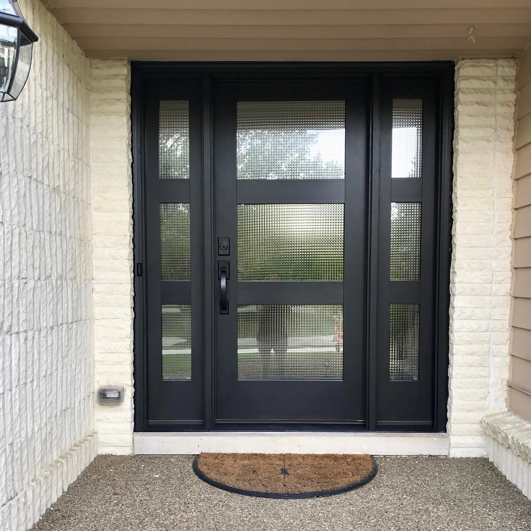 Modern front door installation with decorative glass